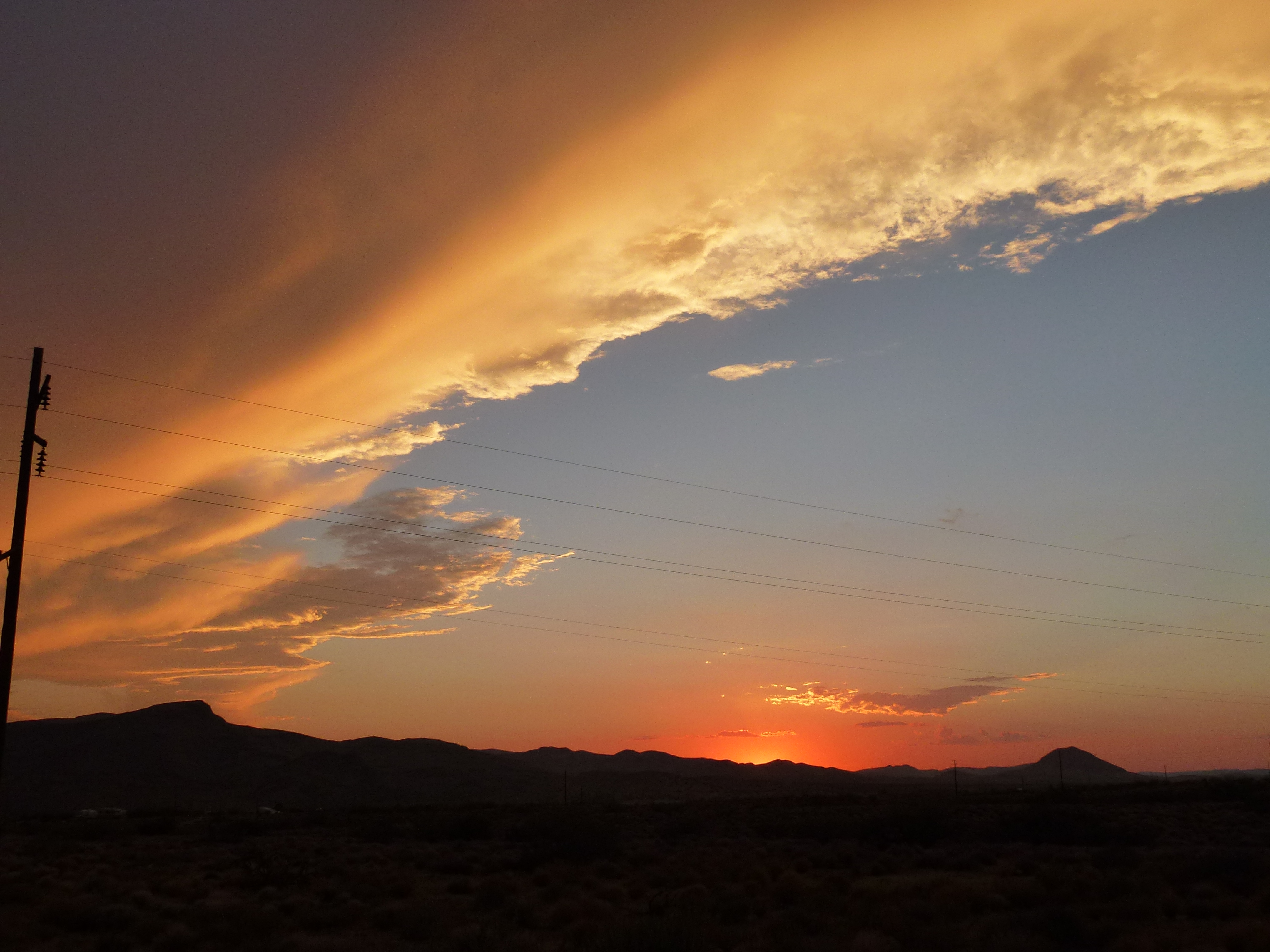 Sunset clouds over a Golden Valley mountain silhouette